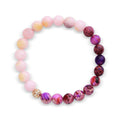 Bracelet with soft pink and violet imitation stones and a gold-tone decorative bead