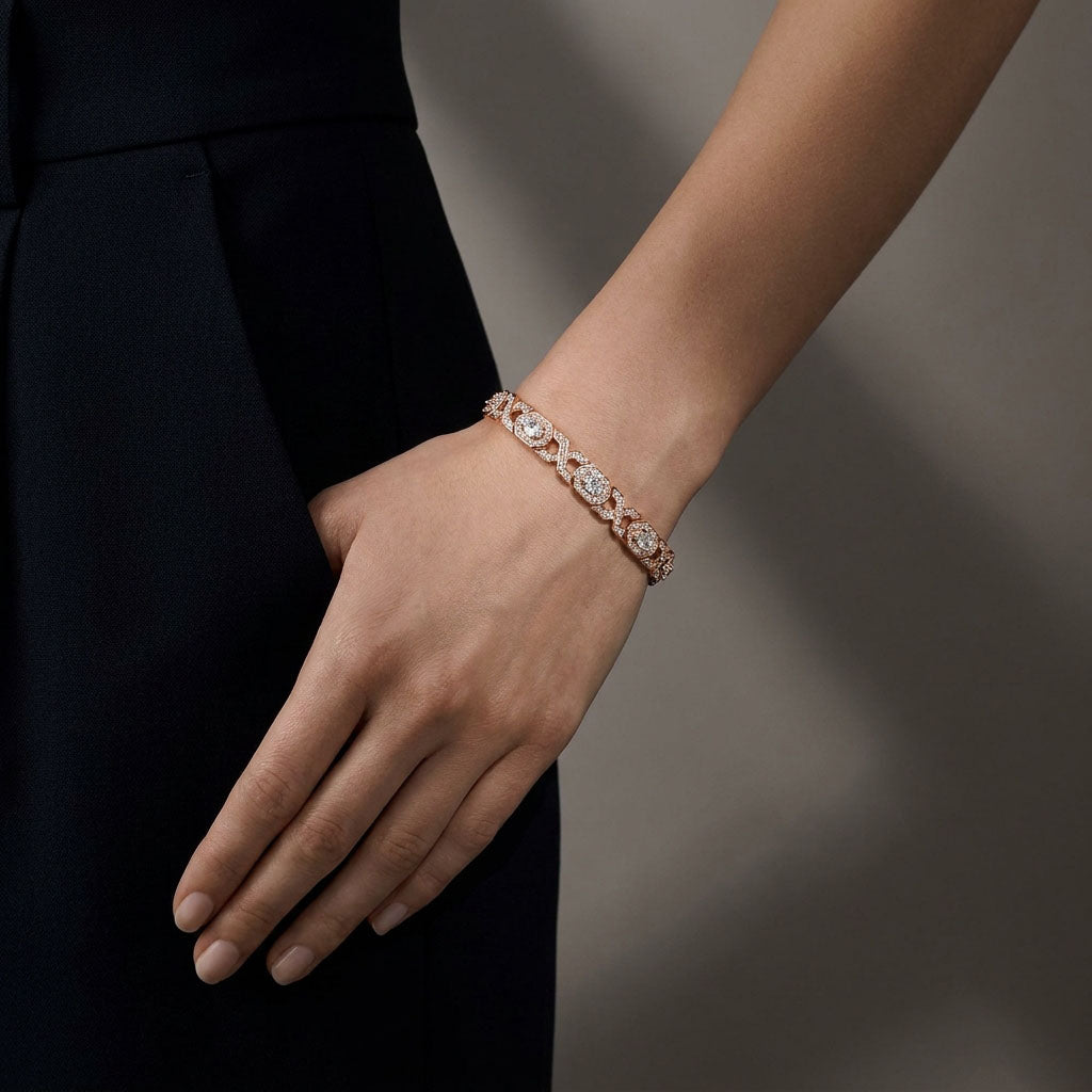 Rose gold tone crystal bracelet on a woman's wrist beside a dark dress