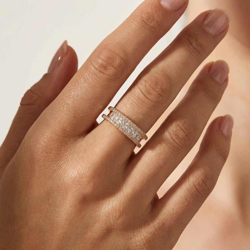 Gold-tone cubic zirconia ring on a model's finger, showing its width and sparkle