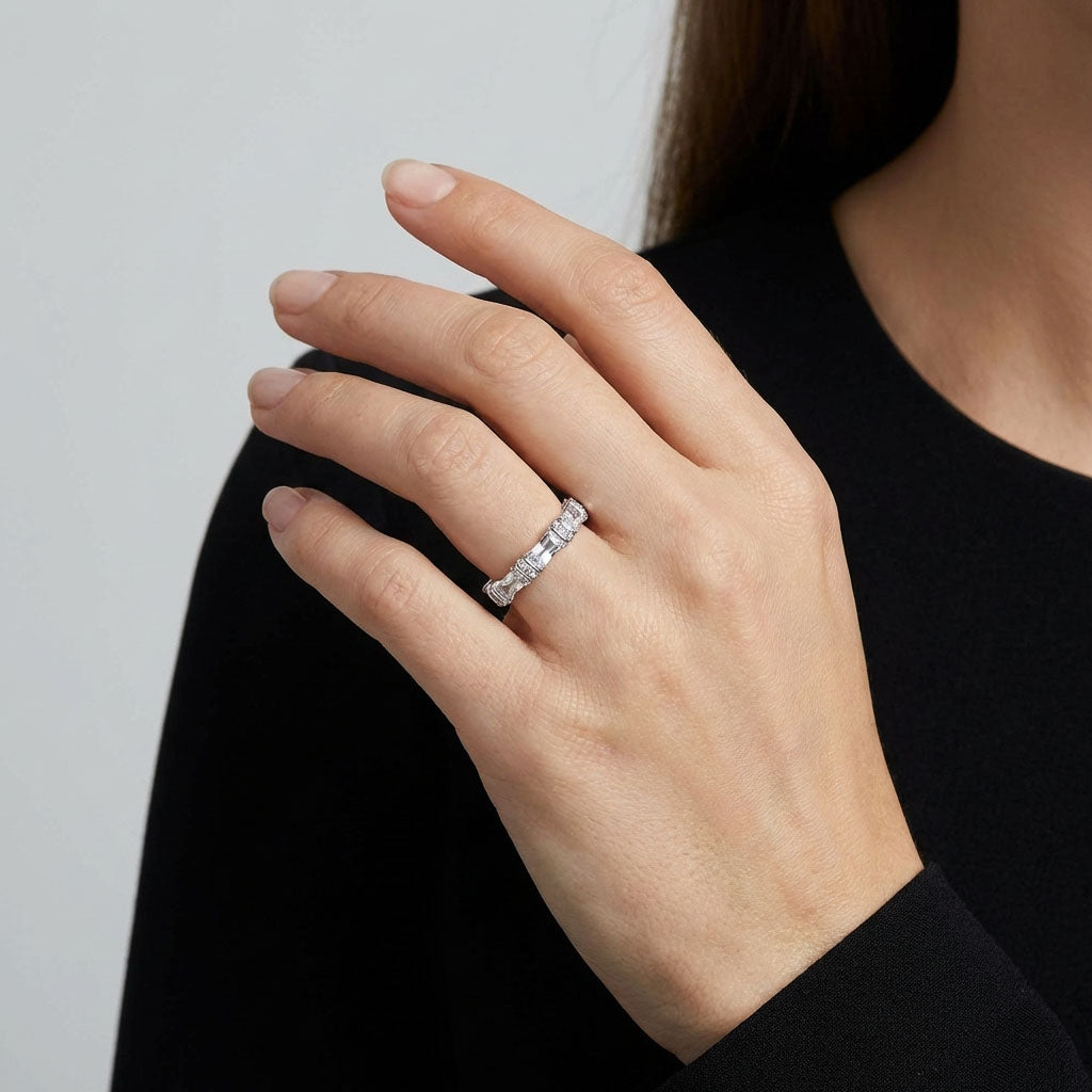 Model in a black jumper wearing a silver-tone cubic zirconia ring