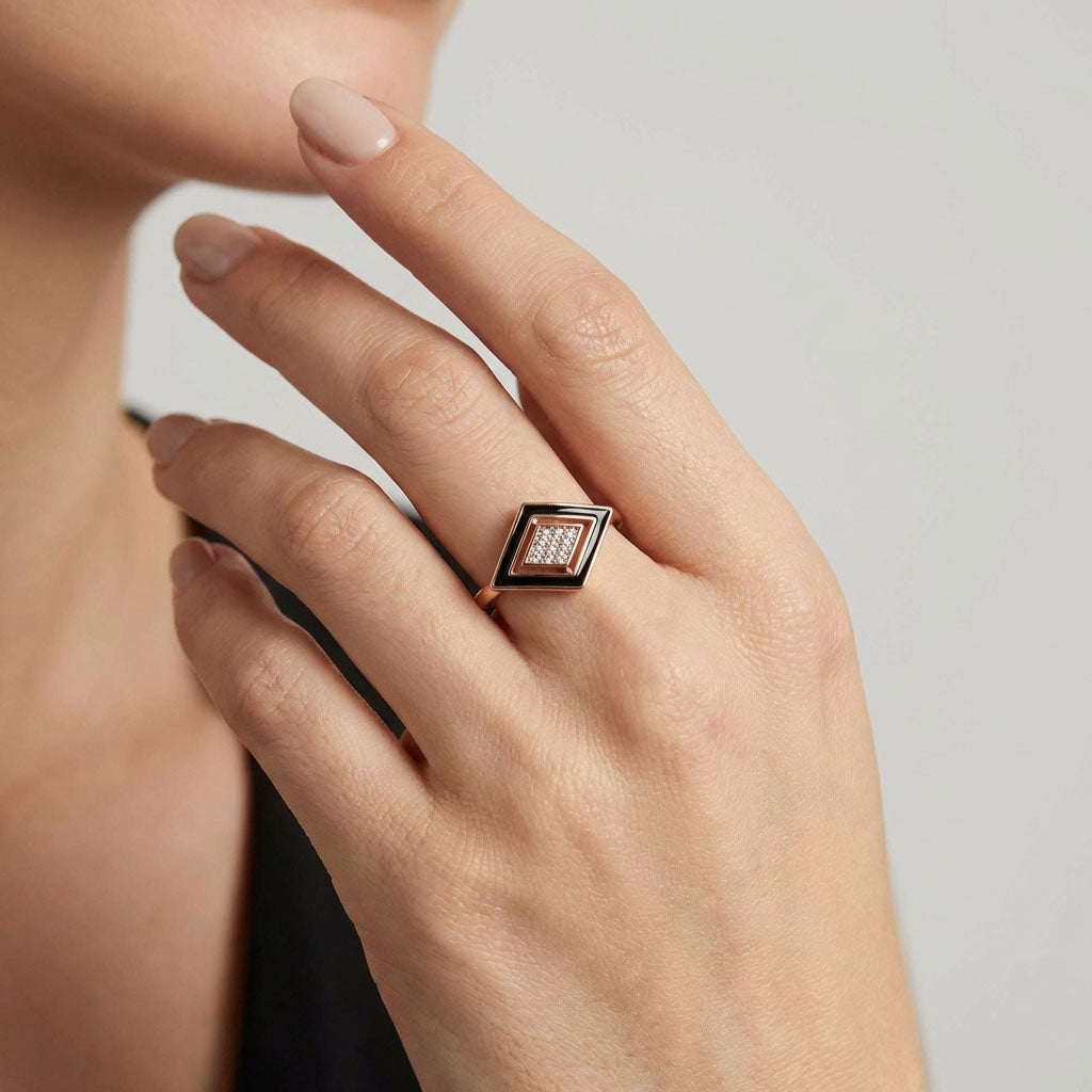 Rhombus ring with black enamel and clear stones on a woman's finger