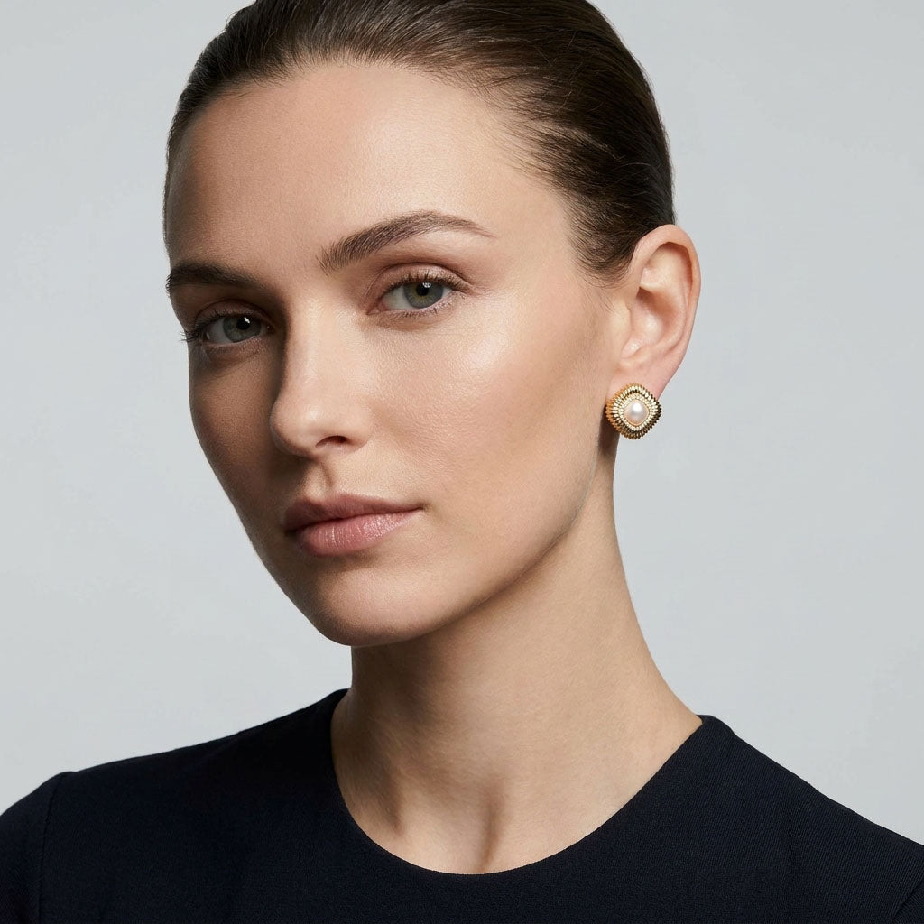 Model in a black top wearing a faux pearl and zirconia earring