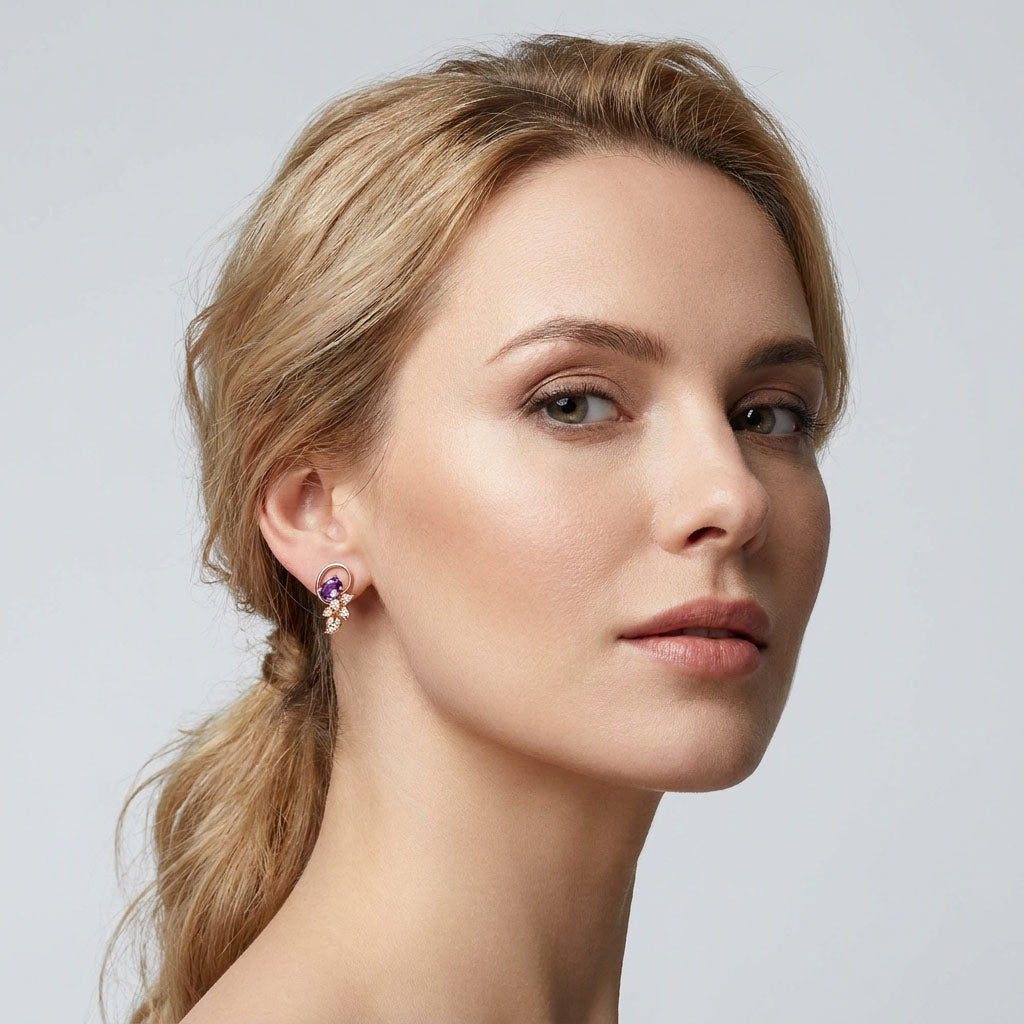 Model wearing gold-plated studs with a violet oval stone and white leaves