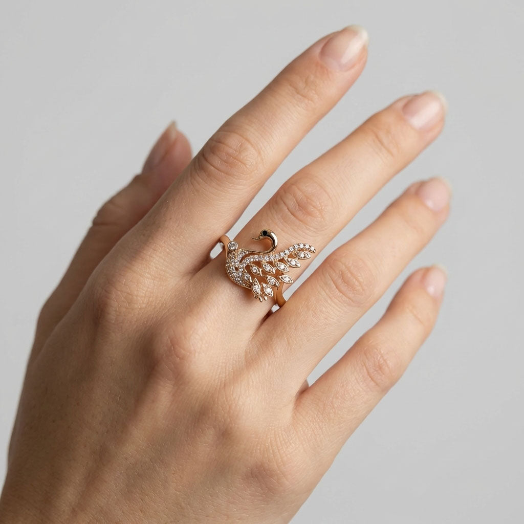 Swan ring on a woman's finger with sparkling stones on the wings