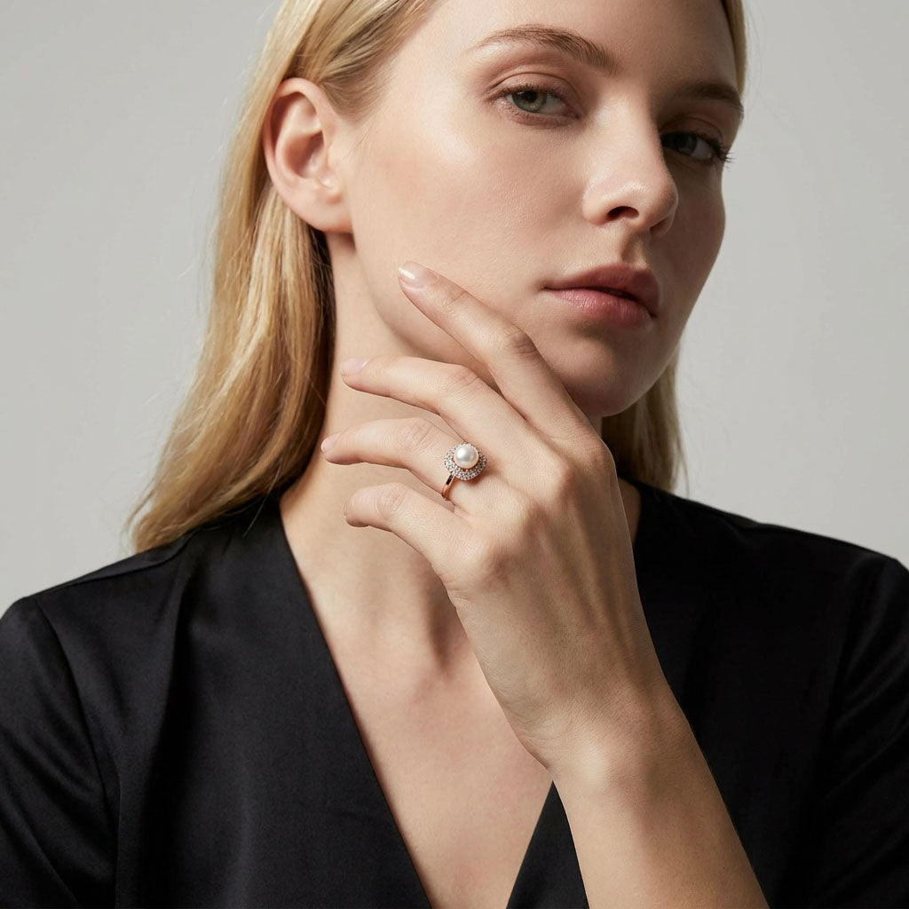 Blonde model wearing a gold-plated pearl ring with a double cubic zirconia border