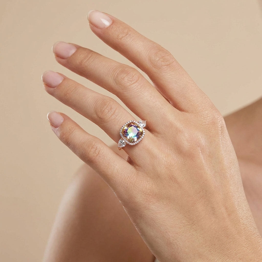 Multicoloured stone ring on a model's finger, showing its width and teardrop side stones