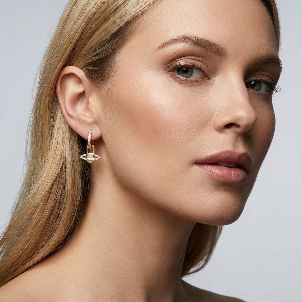 Model wearing Saturn earrings, the planet drop with cubic zirconia sparkling by the ear