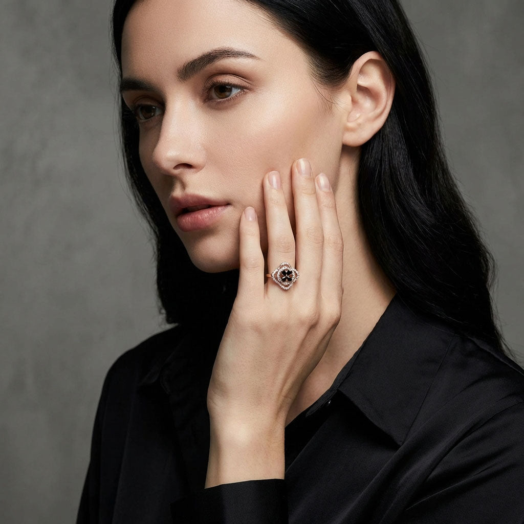 Black flower ring with a cubic zirconia border on a model's finger