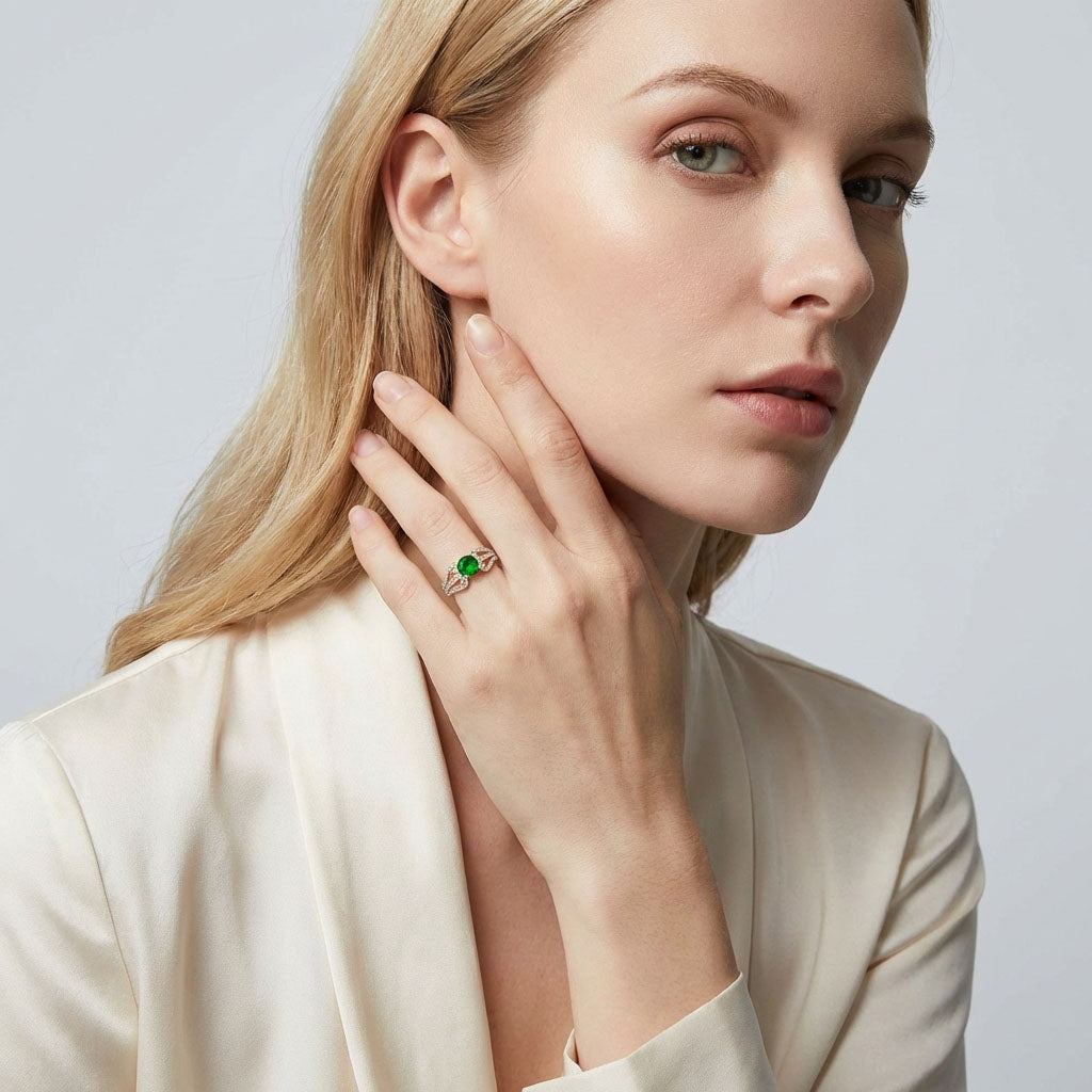 Model wearing the green cubic zirconia ring, hand raised to her cheek