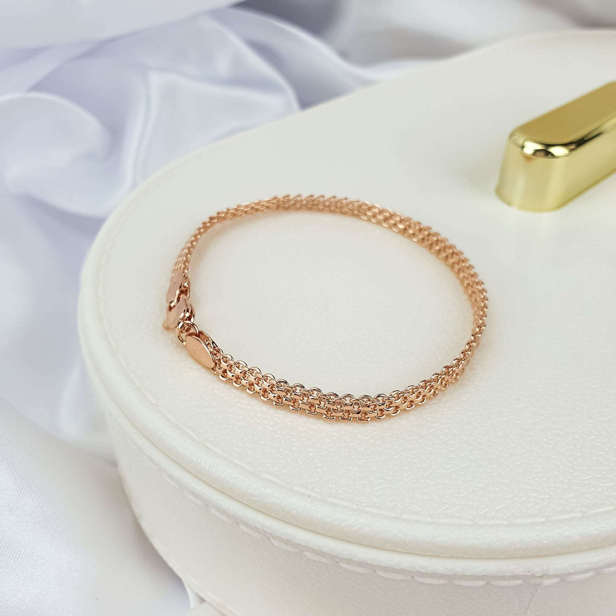 Fine Bismarck chain bracelet on a cream jewellery box with silk