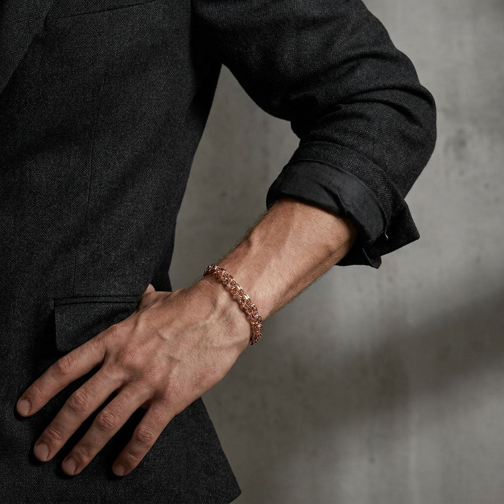 Wide Garibaldi bracelet in a rose gold tone on a man's wrist