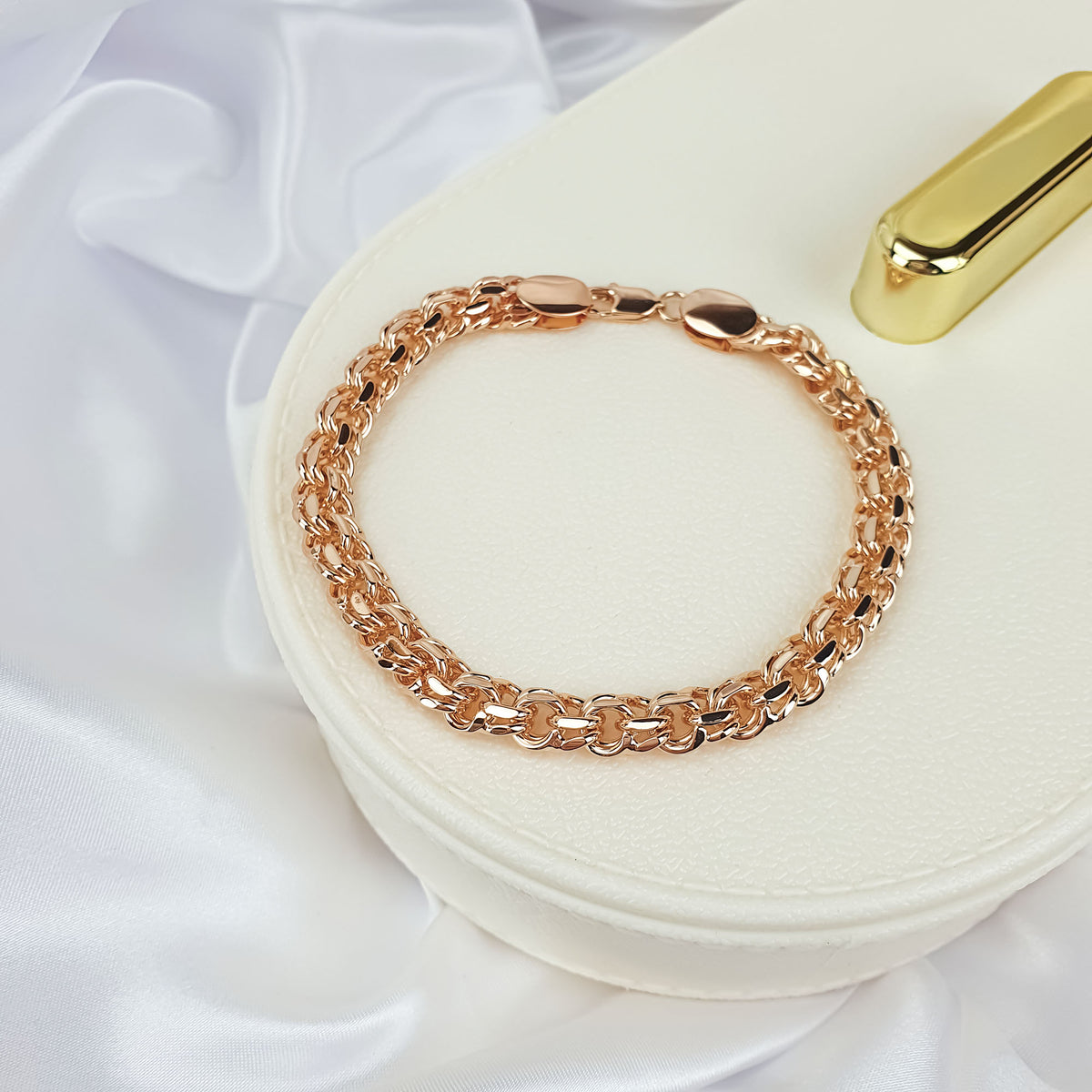 Chunky gold-plated Garibaldi bracelet on a light jewellery box