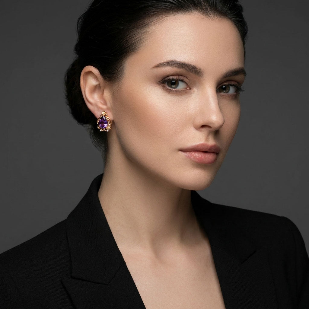 Gold-plated violet clip-on earring on a dark-haired model against grey