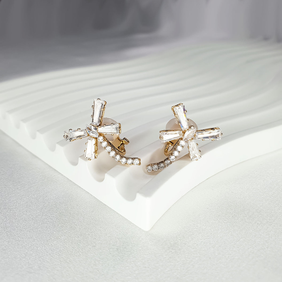 Dragonfly clip-on earrings from the side, showing the clip on a stand