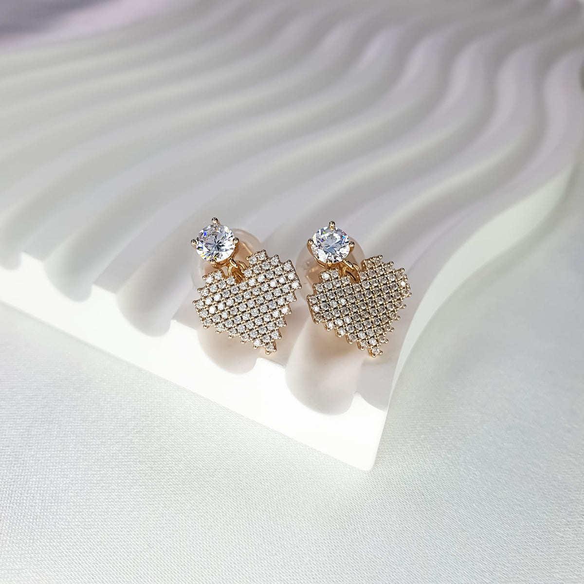 Heart earrings with a fine cubic zirconia mosaic and a round top stone