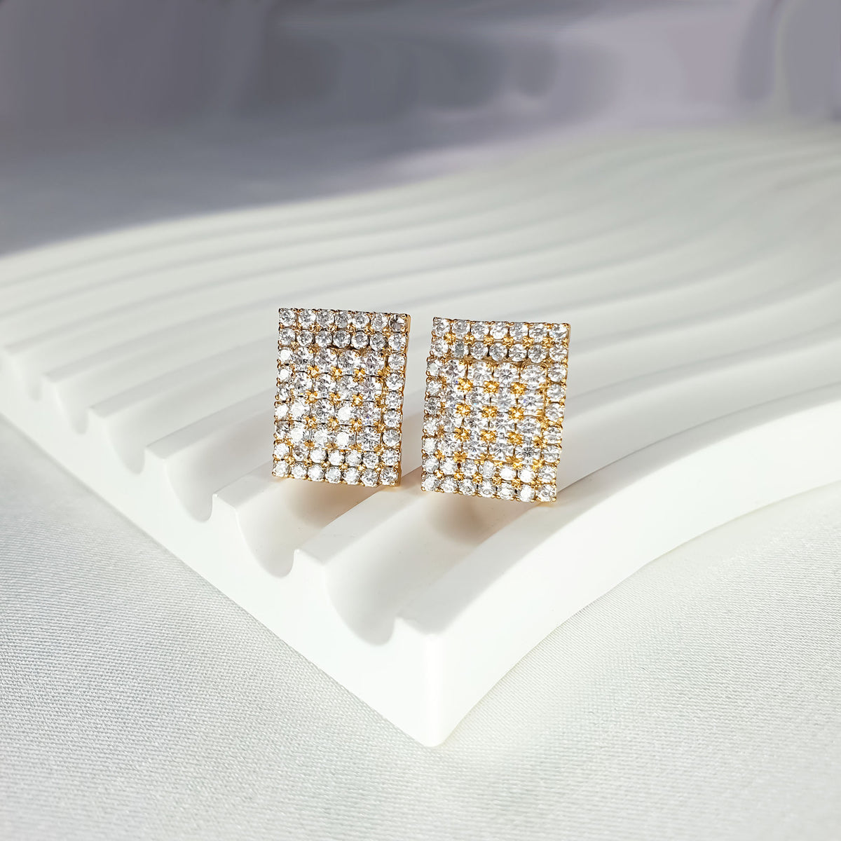 Square clip-on earrings with a clear crystal mosaic in a gold-tone frame