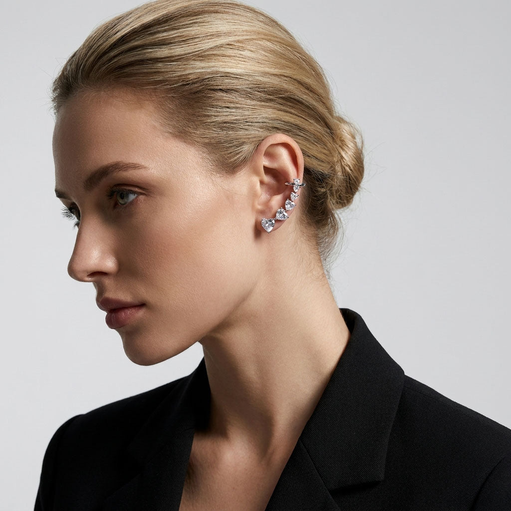 Model in profile wearing platinum-tone earrings that curve along the ear