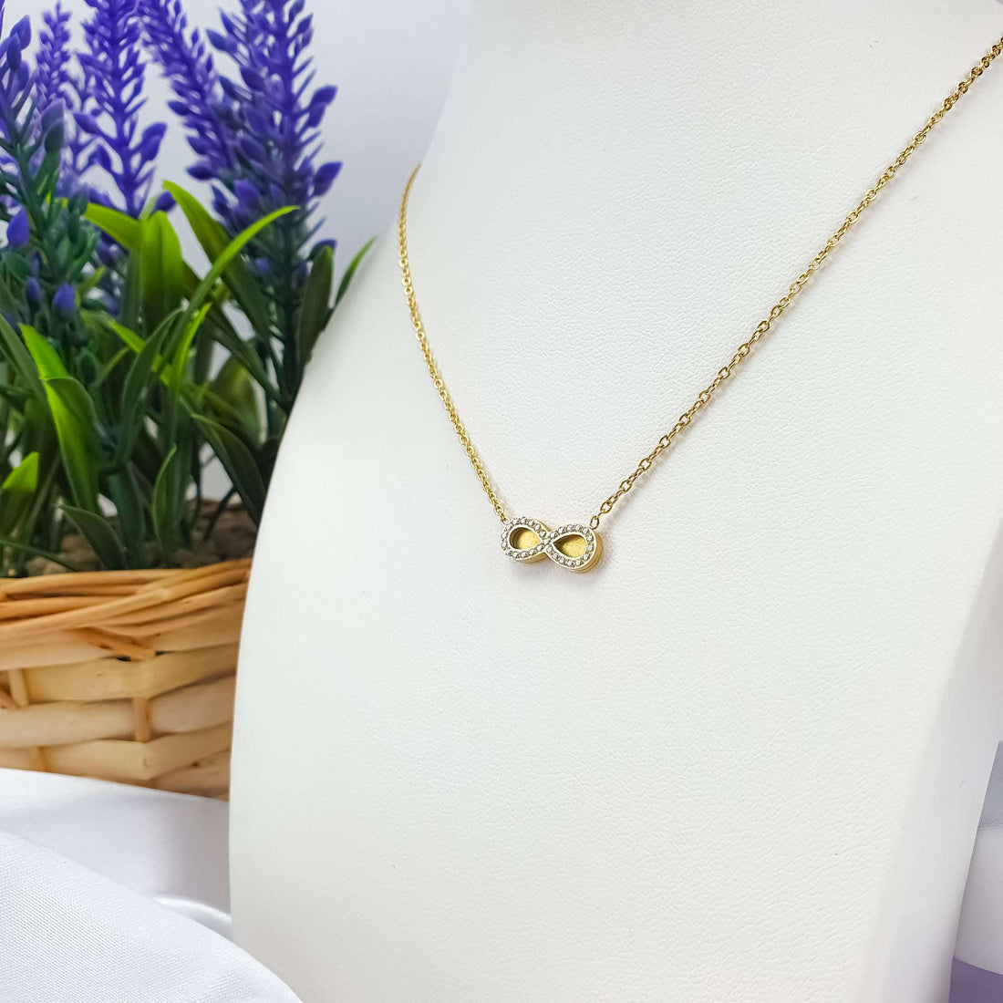 Infinity pendant with cubic zirconia on a gold-plated chain, white bust