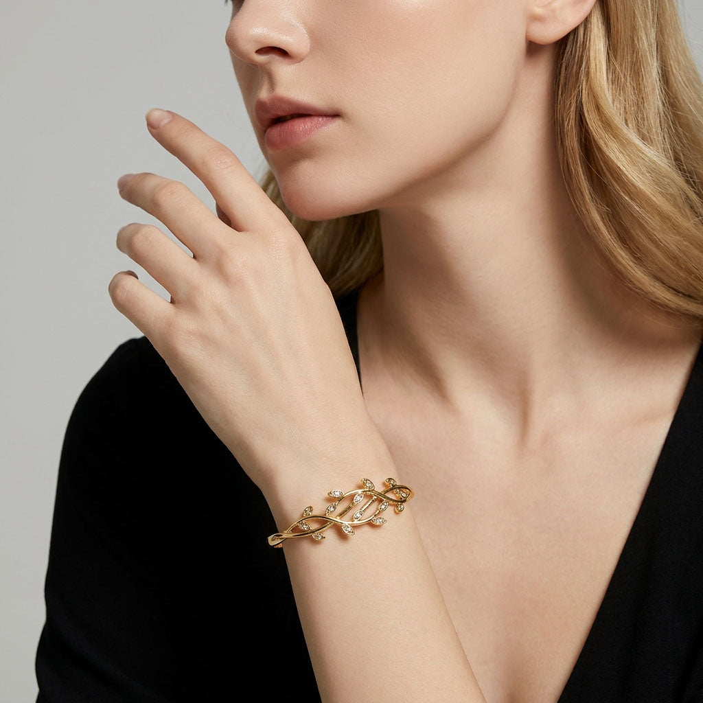 Leaf pattern bangle with white cubic zirconia sparkling on a model's wrist