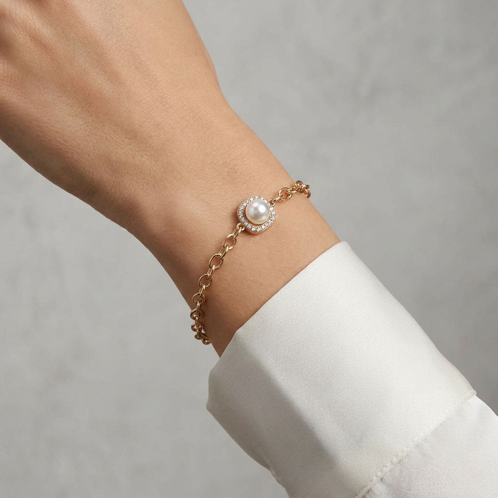 Pearl bracelet on a woman's wrist beside a white shirt cuff