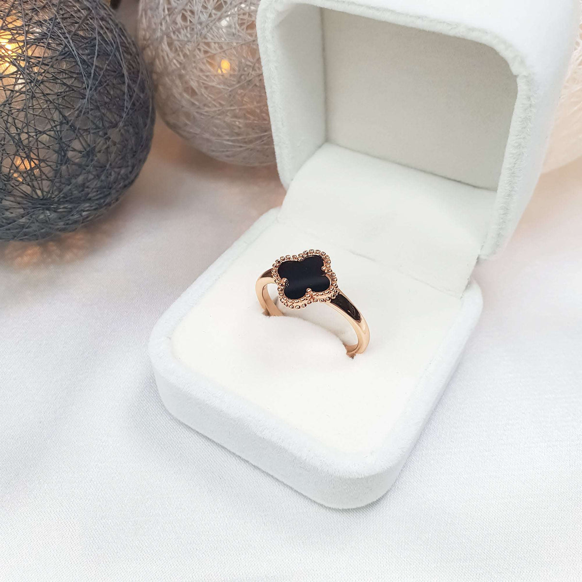 Black enamel clover ring with a beaded rim in a gift box