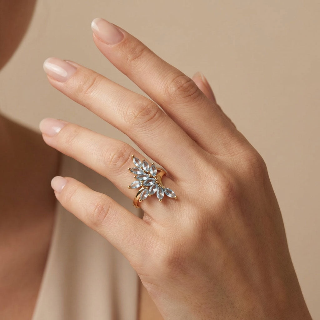 Multi-stone ring with light blue marquise stones on a model's finger