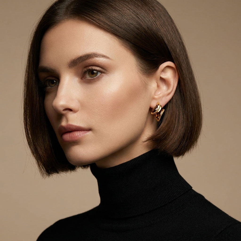 Model in a black polo neck wearing coffee-coloured cubic zirconia earrings