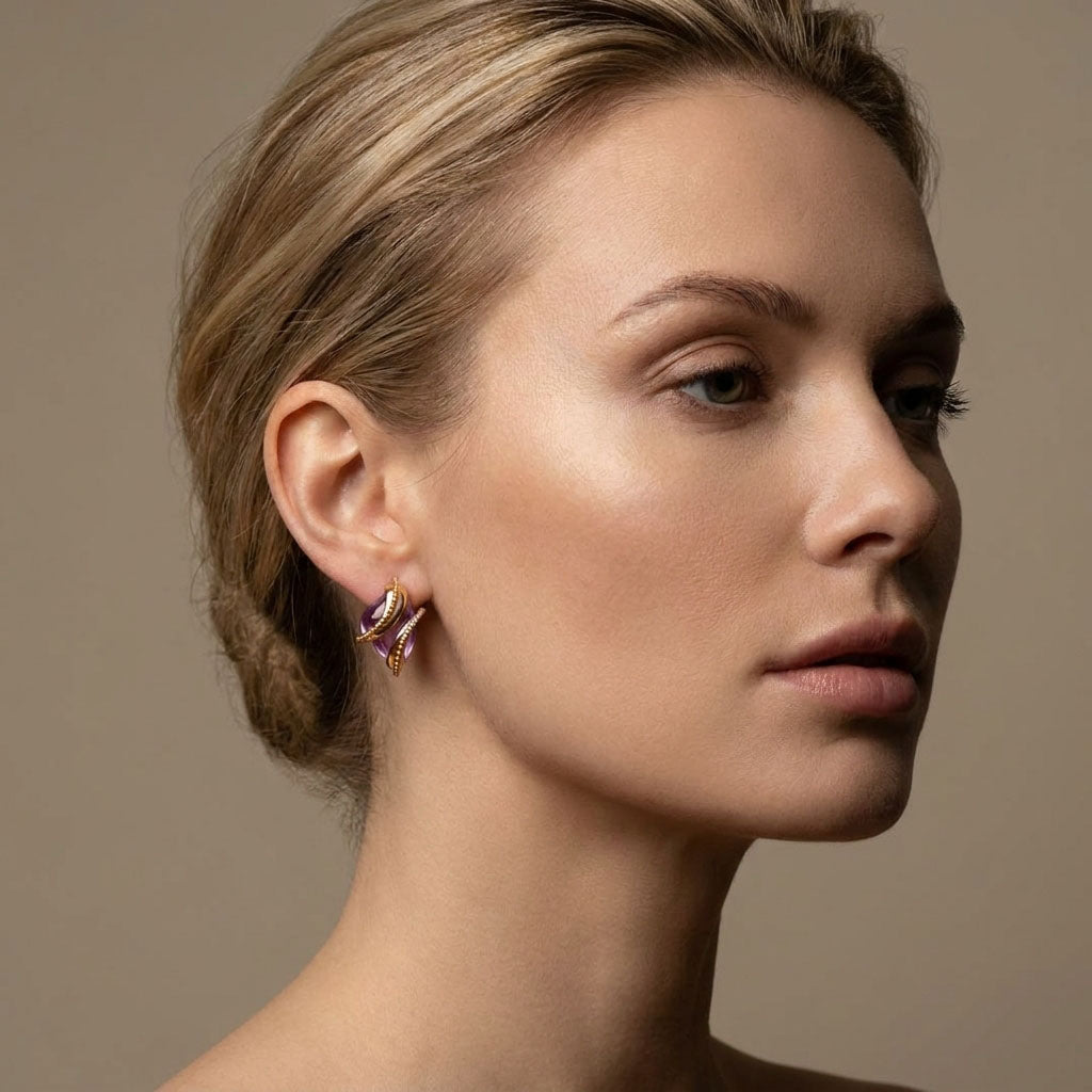 Model in profile wearing lilac stone earrings in a warm gold-tone setting