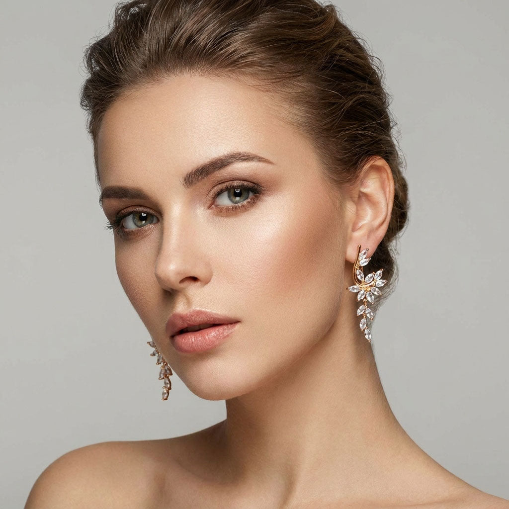Model wearing long flower earrings with a trail of cubic zirconia towards the neck