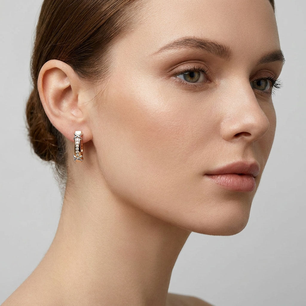Earring on a model's ear showing its compact curved shape and clear stones