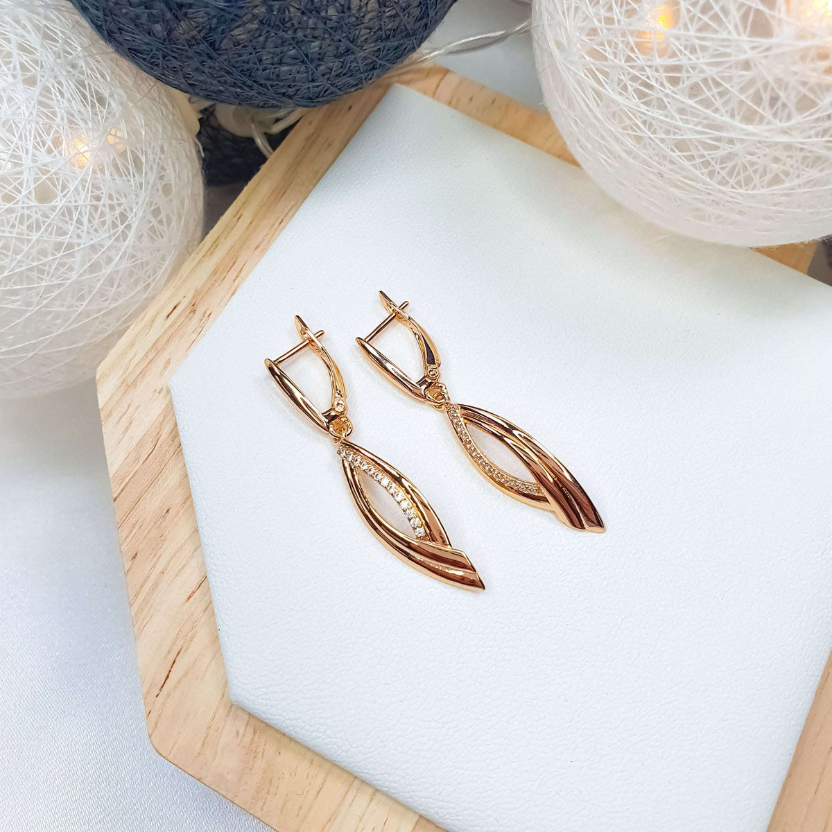 Pair of earrings in festive decor, leverback clasps and cubic zirconia line visible