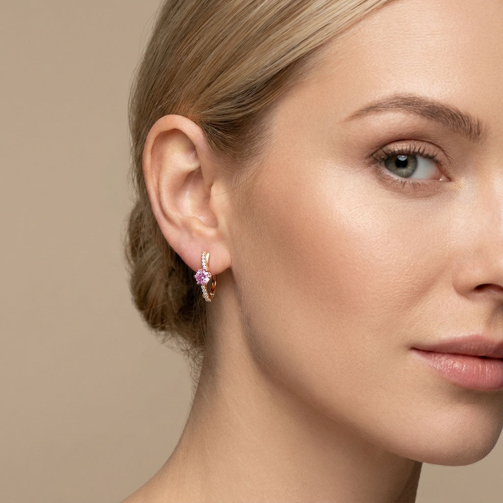 Pink | Pink cubic zirconia earring on a model's ear, gold-plated line with tiny white stones