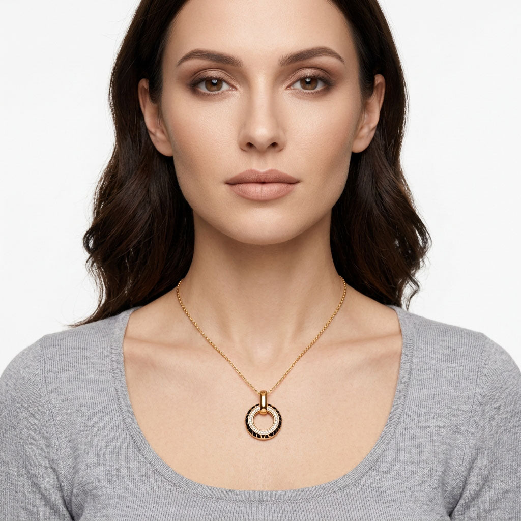 Dark-haired woman in a grey jumper wearing the round leopard print pendant