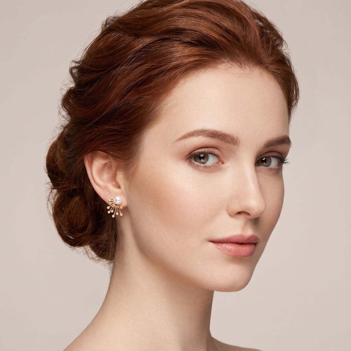Gold-tone pearl fan stud earring worn on the ear