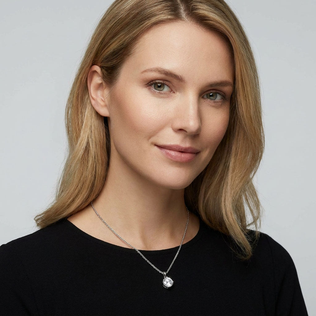 Woman in a black blouse wearing a sparkling cubic zirconia pendant