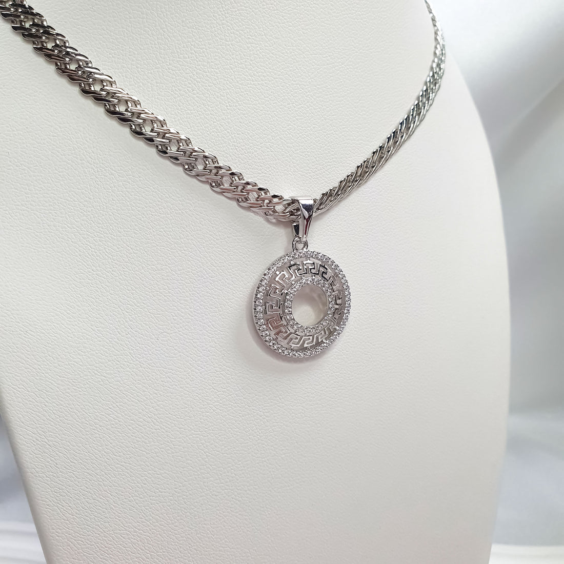 Round Greek meander pendant with cubic zirconia in platinum tone