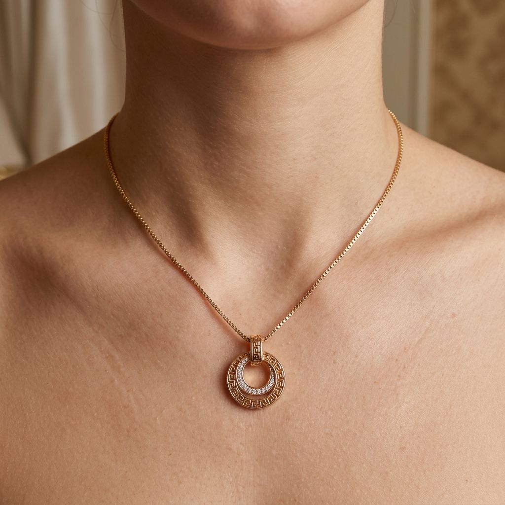 Greek meander double-circle pendant on a fine chain around a model's neck