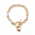 Gold-plated anchor chain bracelet with two white pearls, heart charm and T-bar clasp