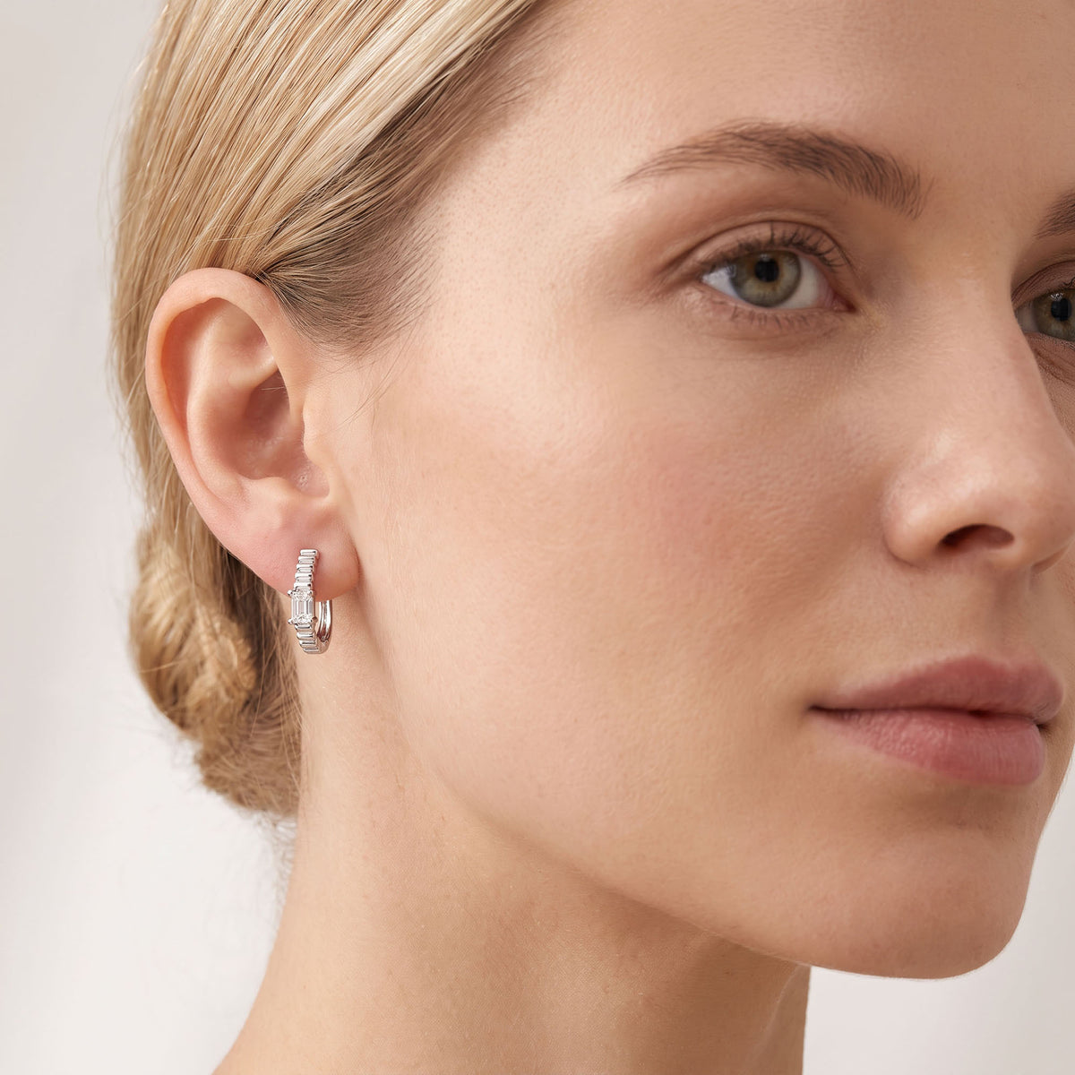 Silver | Silver-tone ribbed earring worn on the ear