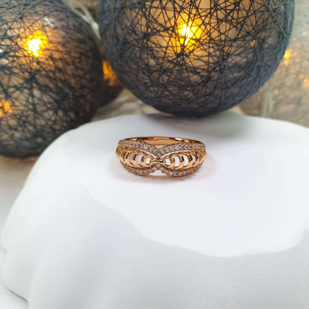 Infinity ring in gold tone, spiral twist between two sparkling cubic zirconia bands