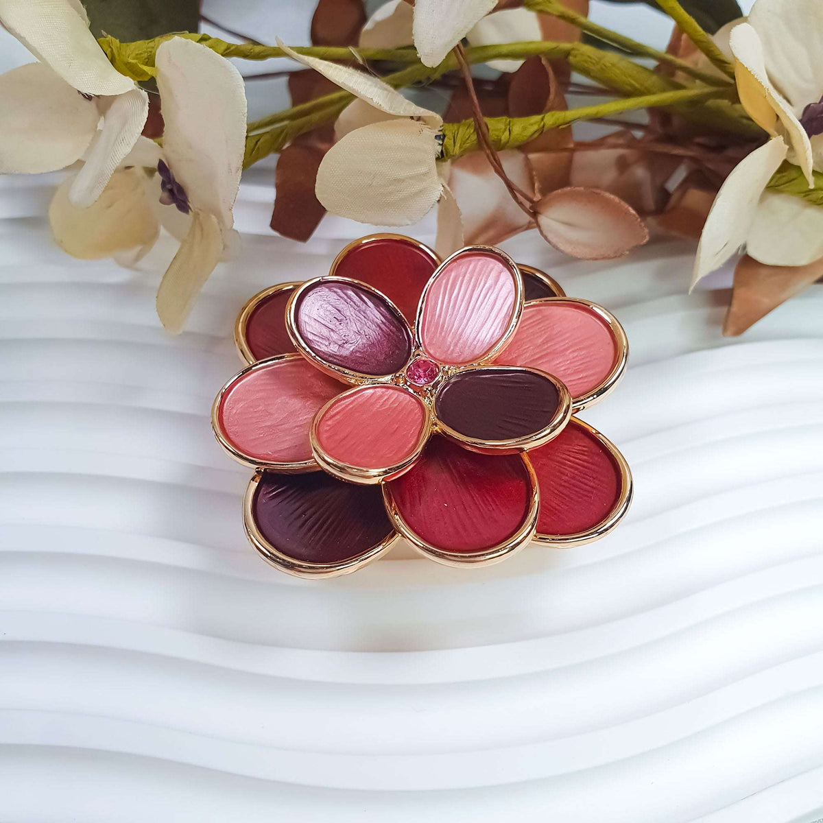 Layered flower brooch in pink and wine red enamel with gold-tone edges