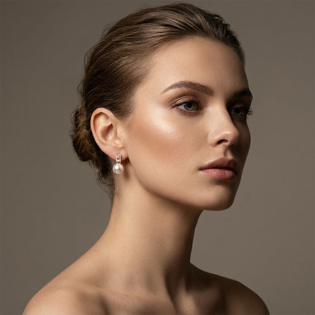 Compact pearl earrings in a woman's ear, gold-plated fitting with cubic zirconia