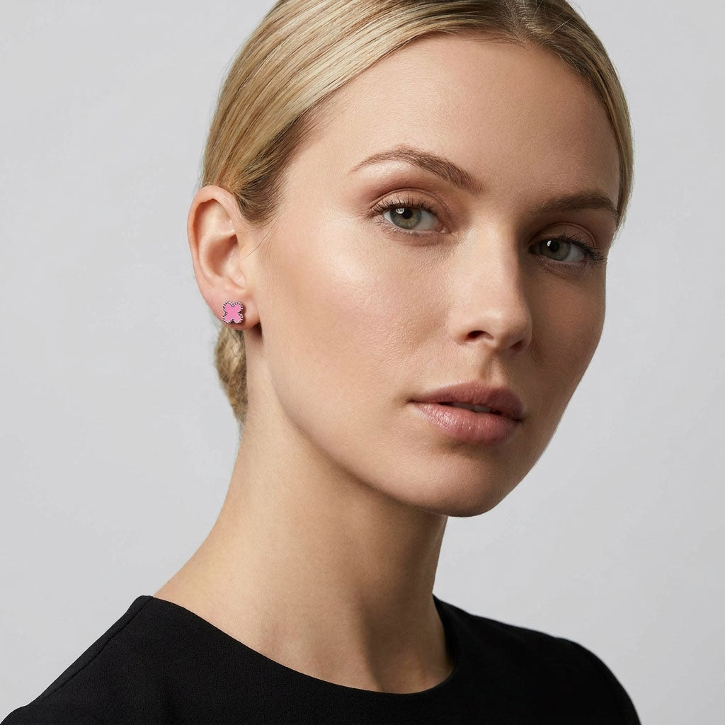 Pink enamel clover stud on a model's ear with a silver-tone beaded edge