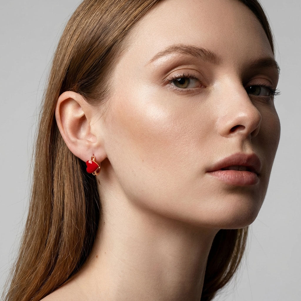 Red enamel heart hoop on a model's ear, gold-plated and compact