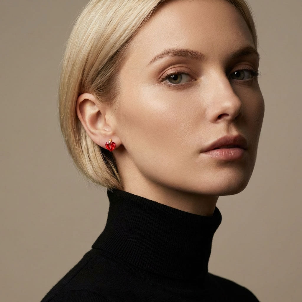 Model in a black polo neck wearing a red heart cubic zirconia earring