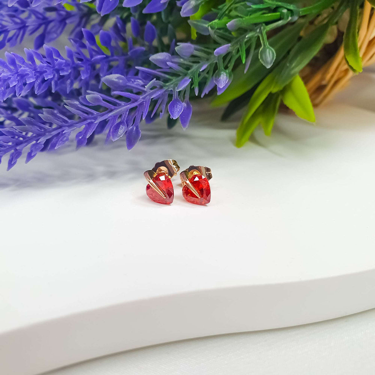 Pair of faceted red heart cubic zirconia studs with gold-tone settings