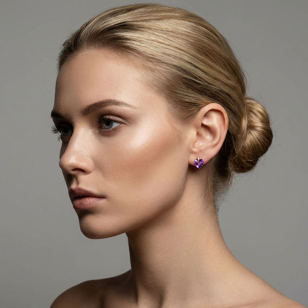 Model wearing a violet heart cubic zirconia stud against a grey background