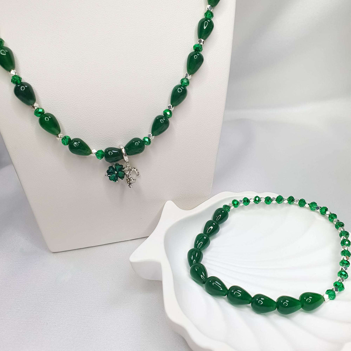 Green glass bead necklace and bracelet with silver-tone spacers and a clover charm