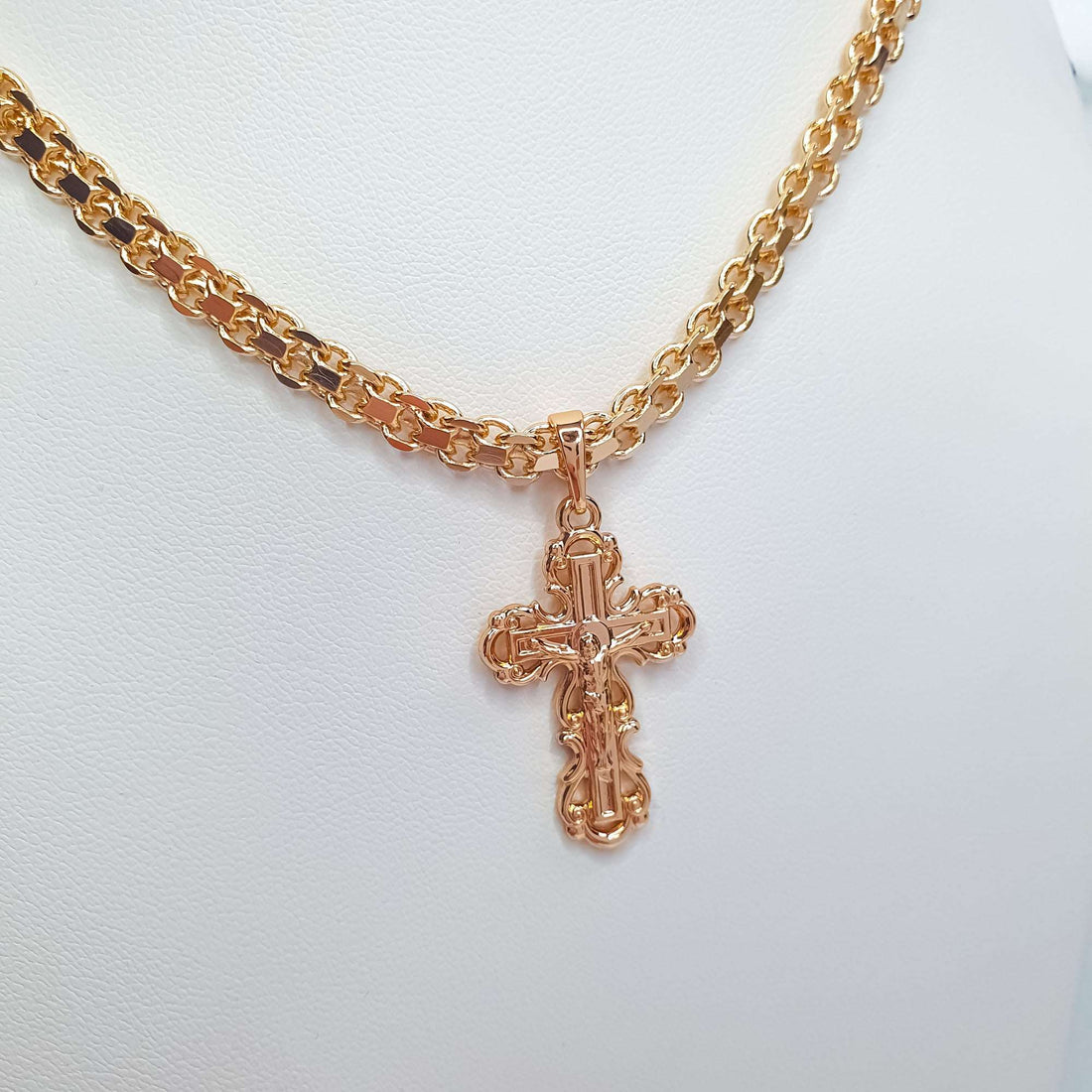 Ornate gold-plated Orthodox cross hanging from a thick link chain