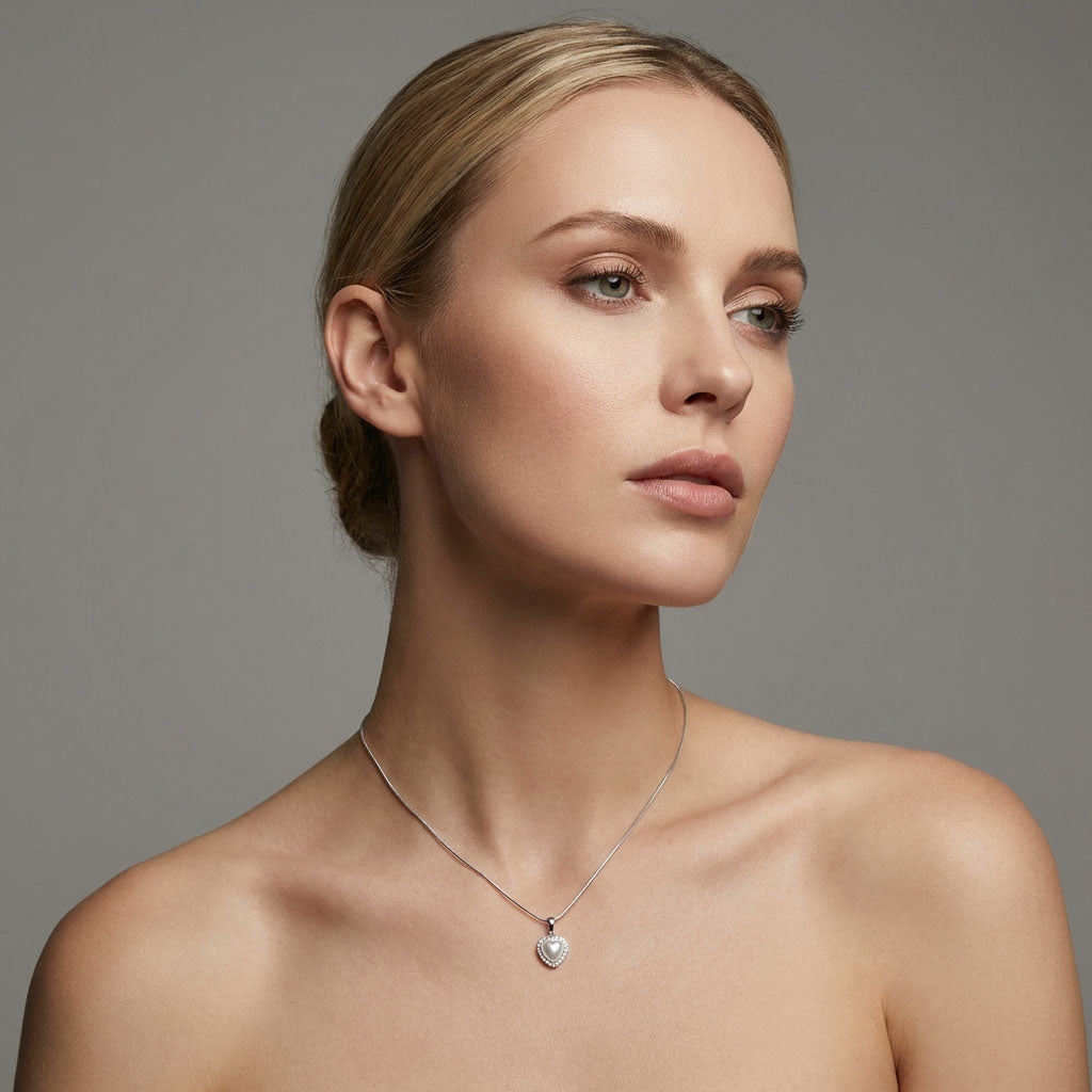 Model wearing the heart pendant on a fine silver-tone chain